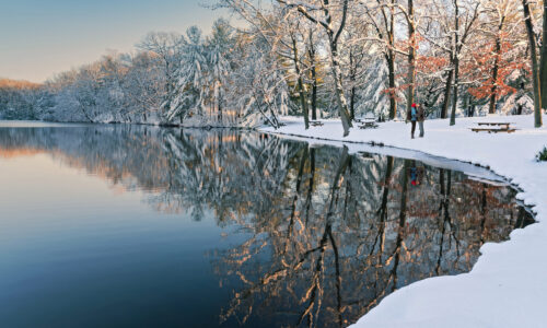 Beautiful,Snowy,Scene,At,Sunset,With,A,Couple,Kissing,In